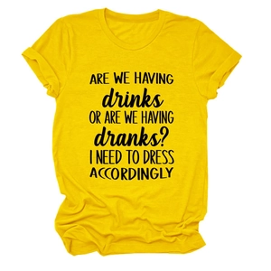Detail of yellow cotton t-shirt with 'ARE WE HAVING DRINKS' slogan text print