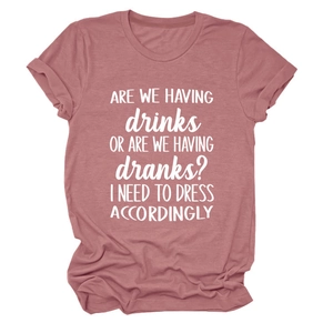 Detailed close-up of a dusty pink crew neck T-shirt featuring white letter print slogan