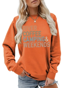 Detailed view of the multicolor letter print on an orange crewneck camping sweatshirt