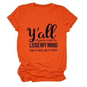 Close-up of the black screen-printed slogan on a bright orange crew neck cotton blend t-shirt