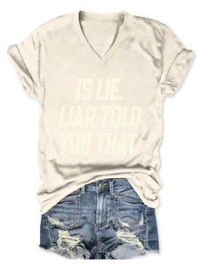 Flat lay view of a V-neck t-shirt with slogan print paired with ripped denim shorts