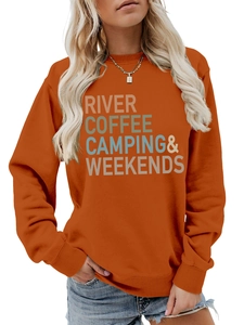 Close-up of orange sweatshirt with River Coffee Camping print and ribbed cuffs