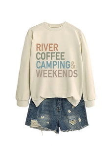 Detail of cream sweatshirt with RIVER COFFEE letters and distressed denim shorts