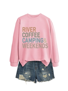 Detail of pink sweatshirt with River Coffee Camping graphic and denim shorts