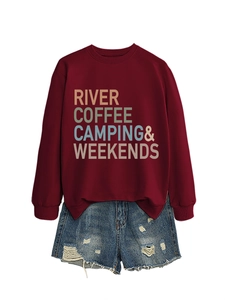 Detail of burgundy crewneck sweatshirt with 'RIVER COFFEE CAMPING' text and denim shorts