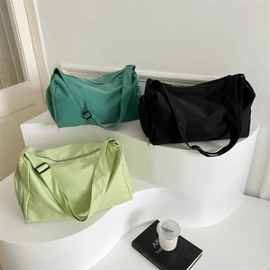 Three colors of Oxford cloth travel sports bags displayed on a minimalist white stage