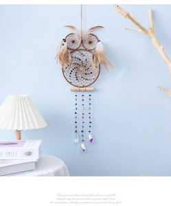 Detail of owl dream catcher featuring natural feathers and crystal bead accents