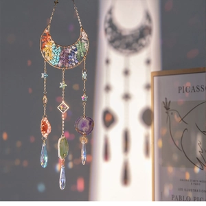 Detail of moon suncatcher with rainbow crystal prisms and colorful natural agate stones