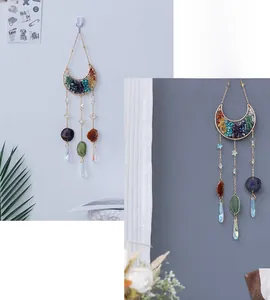 Detail of crescent moon suncatcher with healing crystal stones and agate slice