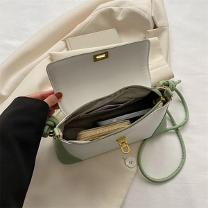 Detail view of the bag interior with contrast color design and metallic twist lock closure