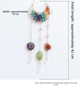 Detail of bohemian suncatcher with colorful chakra stones and hanging crystal prisms