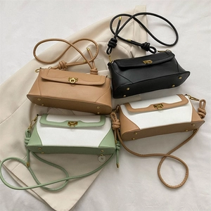 Flat lay of baguette shoulder bags in four colors with gold metal clasps and knot straps