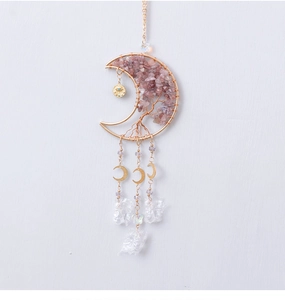 Detail of moon-shaped tree of life wall hanging with pink crystals and gold wire