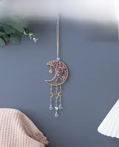 Detail of bohemian gold moon tree of life wall hanging with purple crystal and butterfly