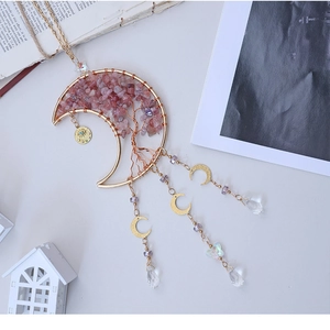 Detailed view of handmade moon tree of life pendant with pink stones and crystal droplets