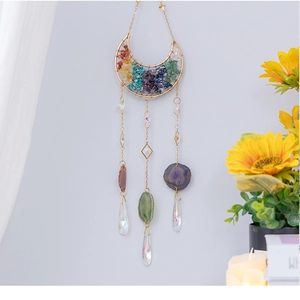 Detail of crescent moon suncatcher with rainbow chakra stones and agate slice pendants