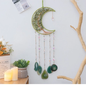 Detail of tree of life dreamcatcher with green crystal stones and agate slices