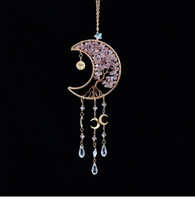 Detail of moon-shaped crystal pendant with Tree of Life wire wrap and pink quartz stones