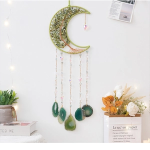 Detail of a moon-shaped Tree of Life wall hanging with green stones and agate slices