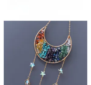 Detail of crescent moon wire-wrapped suncatcher with colorful crystals and star charms