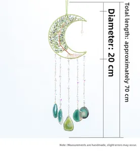 Detail of moon-shaped Tree of Life dream catcher with green crystals and agate slices