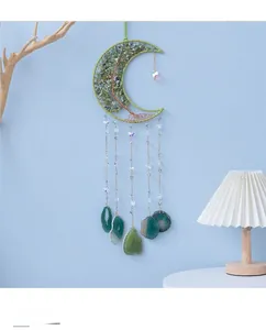 Detailed view of handmade moon dreamcatcher with green crystals and natural agate slices