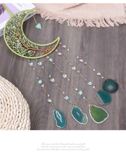 Detail of moon dreamcatcher featuring green crystal tree of life and agate slices