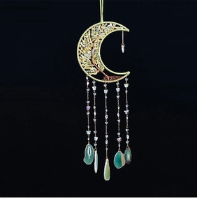 Detail of moon-shaped crystal dreamcatcher with green agate slices and tree of life
