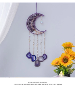 Macro detail of moon-shaped dream catcher with amethyst tree of life and agate slices