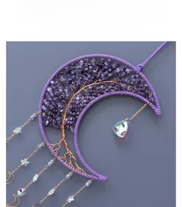 Detail of amethyst crystal tree of life moon dream catcher with metallic star pendants