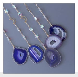 Detail of tree of life agate slices with crescent moon and star hanging ornaments