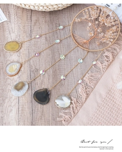 Detail of tree of life dreamcatcher with citrine stones and natural agate slices