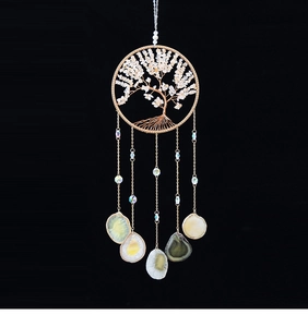 Detail of tree of life wall hanging with white crystals and natural agate slices