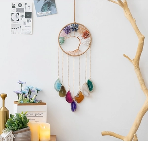 Detailed close-up of tree of life wall decor with natural crystal stones and agate slices