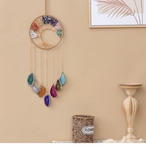 Detail of tree of life wall hanging with colorful crystal stones and agate slices