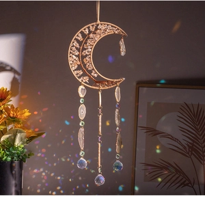 Macro shot of citrine crystal moon suncatcher with intricate bead chains and crystal ball