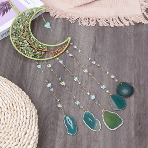 Moon-shaped tree of life dreamcatcher with green crystals and natural agate slices