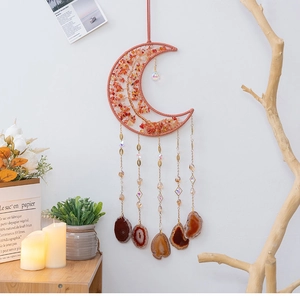 Detail of moon-shaped tree of life wall hanging with agate slices and crystals