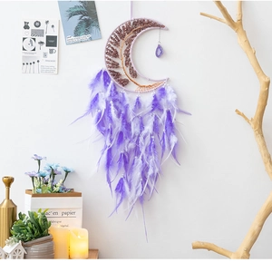 Close-up of handmade purple moon dream catcher with tree of life and feather details