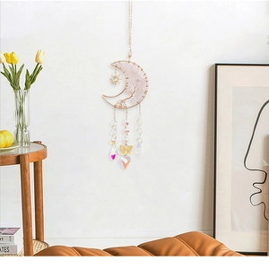 Pink crystal tree of life moon dream catcher hanging on a wall with elegant home decor