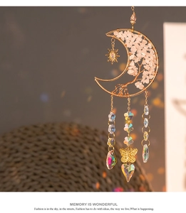 Detailed close-up of rose gold moon tree of life sun catcher with pink crystal stones