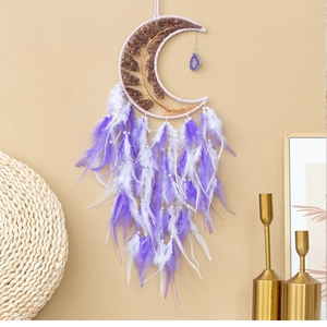 Detail of moon-shaped dream catcher featuring amethyst tree of life and purple feathers
