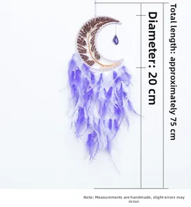 Detail of handmade moon dreamcatcher with tree of life and purple feathers decoration