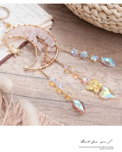 Detail of rose quartz tree of life moon pendant with hanging crystal sun and butterfly charms