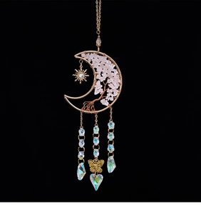 Detail of moon tree of life car charm with pink crystals and rainbow heart pendant