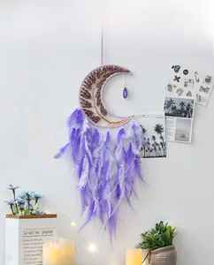 Detail of moon dreamcatcher with purple crystal tree of life and soft feathers