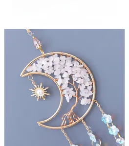 Detail of moon life tree hanging ornament with pink crystal stones and sun pendant