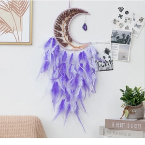 Detail of tree of life wall hanging with purple feathers and strawberry quartz stones