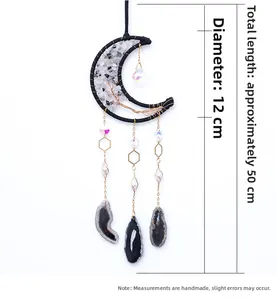 Detail of moon-shaped hanging ornament with white crystal stones and black agate slices