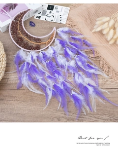 Detailed view of handmade dream catcher with purple feathers and strawberry quartz tree